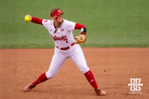 Nebraska Cornhusker Ava Kuszak (7) throws to first for an out against the Indiana Hoosiers in the second inning during a college softball game Friday, April 18, 2025 in Omaha, Nebraska. Photo by John S. Peterson.