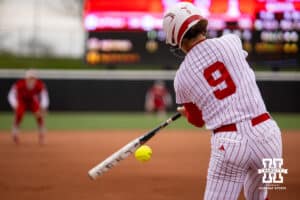 Nebraska Cornhusker Hannah Camenzind (9) gets a hit against the Indiana Hoosiers during a college softball game Friday, April 18, 2025 in Omaha, Nebraska. Photo by John S. Peterson.