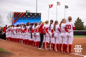 Nebraska Cornhuskers lined up for the National Anthem against the Indiana Hoosiers during a college softball game Friday, April 18, 2025 in Omaha, Nebraska. Photo by John S. Peterson.