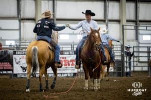 John Cook gives a Nolan Glint a fist bump after their run in the Invitational during the John Cook Roping Classic on Sunday, April 13, 2025 in Lincoln, Nebraska. Photo by John S. Peterson.