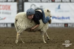 Young mutton buster in the mutton bustin competition during the John Cook Roping Classic on Sunday, April 13, 2025 in Lincoln, Nebraska. Photo by John S. Peterson.