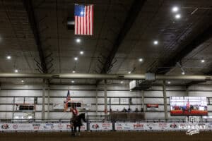 Miss Rodeo Nebraska rode out with American flag for the opening ceremony during the John Cook Roping Classic on Sunday, April 13, 2025 in Lincoln, Nebraska. Photo by John S. Peterson.