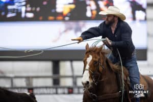 A cowboy throws his rope to head the steer in the team roping competition during the John Cook Roping Classic on Sunday, April 13, 2025 in Lincoln, Nebraska. Photo by John S. Peterson.