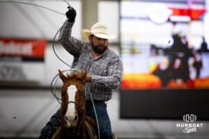 A cowboy ready to throw his rope to catch the rear legs of the steer during the John Cook Roping Classic on Sunday, April 13, 2025 in Lincoln, Nebraska. Photo by John S. Peterson.