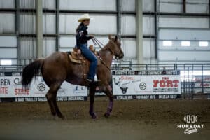 Lindsay Peterson watching the action as she helps with the steers during the John Cook Roping Classic on Sunday, April 13, 2025 in Lincoln, Nebraska. Photo by John S. Peterson.