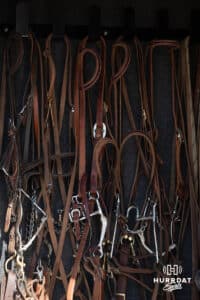 Bridles hanging in the trailer as John and Taylor Cook prepare their horses for day at the John Cook Roping Clinic on Saturday, April 12, 2025 in Lincoln, Nebraska. Photo by John S. Peterson.