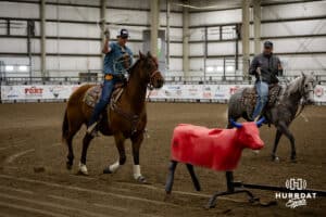 Young cowboy getting instruction on healing, catching the rear legs with a rope, by a coach during the John Cook Roping Clinic on Saturday, April 12, 2025 in Lincoln, Nebraska. Photo by John S. Peterson.