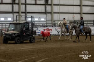 Young cowgirl getting instruction on healing, catching the rear legs with a rope, by a coach during the John Cook Roping Clinic on Saturday, April 12, 2025 in Lincoln, Nebraska. Photo by John S. Peterson.