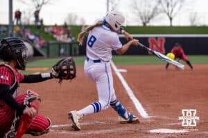 Creighton Bluejay catcher Lily West (8) singles in the third inning loading up the bases against the Nebraska Cornhuskers during a college softball game Wednesday, April 4, 2025 in Lincoln, Nebraska. Photo by John S. Peterson.