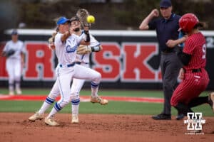 Creighton Bluejay shortstop Ashten Pierson (4) turns a double play getting Nebraska Cornhusker Hannah Camenzind (9) out at second before throwing to first during a college softball game Wednesday,April 4, 2025 in Lincoln, Nebraska. Photo by John S. Peterson.