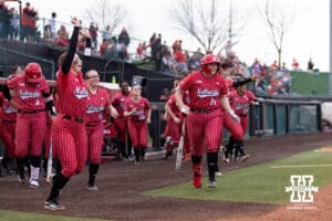 Nebraska Cornhuskers dugout clears out to home plate to celebrate Samantha Bland's home run against the Creighton Bluejays in the second inning during a college softball game Wednesday,April 4, 2025 in Lincoln, Nebraska. Photo by John S. Peterson.