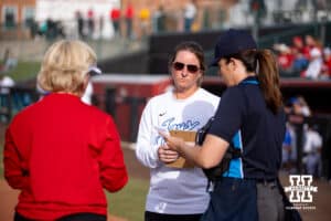 Creighton Bluejay head coach Krista Wood meeting at home plate with Nebraska Cornhusker head coach Rhonda Revelle and the umpire during a college softball game Wednesday,April 4, 2025 in Lincoln, Nebraska. Photo by John S. Peterson.