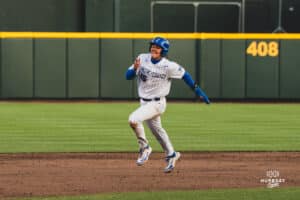 Creighton Bluejay Kyle Hess running to third base during a baseball game at Charles Schwab Field on April 8th, 2025 in Omaha Nebraska. Photo by Collin Stilen.