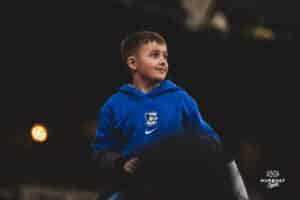 Creighton Bluejay fan wins a rug during a baseball game at Charles Schwab Field on April 8th, 2025 in Omaha Nebraska. Photo by Collin Stilen.