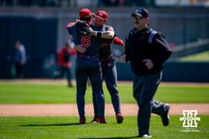 Rutgers Scarlet Knight Pablo Santos (6) and Ty Doucette (36) hug after taking the win against the Nebraska Cornhuskers in the ninth inning during a college baseball game Sunday, April 6, 2025 in Lincoln, Nebraska. Photo by John S. Peterson.