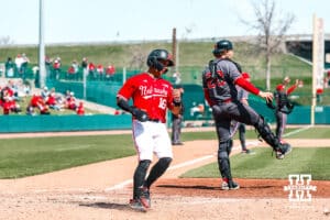 Nebraska Cornhusker infielder Devin Nunez (16) scores a run against the Rutgers Scarlet Knights during a college baseball game Sunday, April 6, 2025 in Lincoln, Nebraska. Photo by Jansen Coburn.