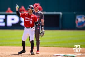 Nebraska Cornhusker utility Cayden Brumbaugh (0) celebrates a single in the sixth inning against Rutgers Scarlet Knight infielder Ty Doucette (36) during a college baseball game Sunday, April 6, 2025 in Lincoln, Nebraska. Photo by John S. Peterson.