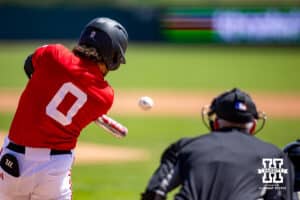 Nebraska Cornhusker utility Cayden Brumbaugh (0) singles in the sixth inning against the Rutgers Scarlet Knights during a college baseball game Sunday, April 6, 2025 in Lincoln, Nebraska. Photo by John S. Peterson.