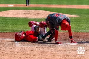 Nebraska Cornhusker utility Will Jesske (13) gets injuried when Rutgers Scarlet Knight infielder Yomar Carreras (12) slid home during a college baseball game Sunday, April 6, 2025 in Lincoln, Nebraska. Photo by Jansen Coburn.