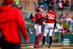 Nebraska Cornhusker catcher Will Jesske (13) goes to the mound to talk to the pitcher Gavin Blachowicz (50) during a college baseball game Sunday, April 6, 2025 in Lincoln, Nebraska. Photo by John S. Peterson.