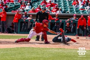 Umpire calls Rutgers Scarlet Knight Pablo Santos (6) safe scoring a run against Nebraska Cornhusker catcher Will Jesske (13) in the fifith inning during a college baseball game Sunday, April 6, 2025 in Lincoln, Nebraska. Photo by Jansen Coburn.