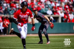 Rutgers Scarlet Knight pitcher Quinn Berglin (9) throws out Nebraska Cornhusker infielder Dylan Carey (15) at first in the fourth inning during a college baseball game Sunday, April 6, 2025 in Lincoln, Nebraska. Photo by John S. Peterson.