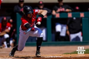 Nebraska Cornhusker infielder Dylan Carey (15) SAC bunts advancing Stone in the fourth inning against the Rutgers Scarlet Knights during a college baseball game Sunday, April 6, 2025 in Lincoln, Nebraska. Photo by John S. Peterson.