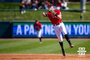 Nebraska Cornhusker infielder Dylan Carey (15) throws to first for an out in the fourth inning against the Rutgers Scarlet Knights during a college baseball game Sunday, April 6, 2025 in Lincoln, Nebraska. Photo by John S. Peterson.