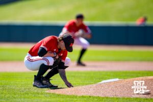 Nebraska Cornhusker pitcher Jackson Brockett (33) writes something on the back of the mound before pitching against the Rutgers Scarlet Knights during a college baseball game Sunday, April 6, 2025 in Lincoln, Nebraska. Photo by John S. Peterson.