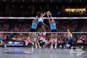 Omaha Supernovas Kaitlyn Hord (23) spikeds the ball against Orlando Valkyrie Natalie Foster (13) and Courtney Schwan (4) in the first set during a professional volleyball match Saturday, April 5, 2025 in Omaha, Nebraska. Photo by John S. Peterson.