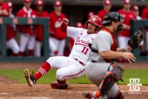 Nebraska Cornhusker utility Max Buettenback (11) slides at home plate for a run against the Oregon State Beavers in the sixth inning during a college baseball game Saturday, March 29, 2025 in Lincoln, Nebraska. Photo by John S. Peterson.