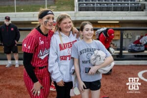 Nebraska Cornhusker Jordyn Bahl (98) poses with some young fans after a college softball game against the Omaha Mavericks on Wednesday, March 26, 2025, in Omaha, Nebraska. Photo by John S. Peterson.