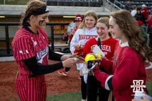 Nebraska Cornhusker Jordyn Bahl (98) signs some autographs after a college softball game against the Omaha Mavericks on Wednesday, March 26, 2025, in Omaha, Nebraska. Photo by John S. Peterson.
