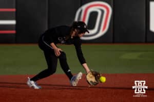 Omaha Mavericks Maggie O'Brien scoops up the ball to throw to first for an out against the Nebraska Cornhuskers during a college softball game on Wednesday, March 26, 2025, in Omaha, Nebraska. Photo by John S. Peterson.