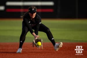 Omaha Mavericks Katherine Johnson scoops up the ball to throw to first for an out against the Nebraska Cornhuskers in the sixth during a college softball game on Wednesday, March 26, 2025, in Omaha, Nebraska. Photo by John S. Peterson.