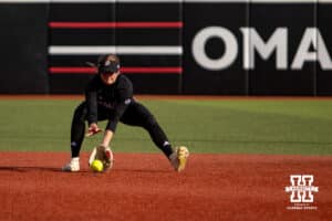 Omaha Mavericks Katherine Johnson scoops up the ball against the Nebraska Cornhuskers in the first during a college softball game on Wednesday, March 26, 2025, in Omaha, Nebraska. Photo by John S. Peterson.