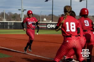 Nebraska Cornhusker Ava Bredwell (24) scores from a Olivia DiNardo home run in the first against the Omaha Mavericks during a college softball game on Wednesday, March 26, 2025, in Omaha, Nebraska. Photo by John S. Peterson.