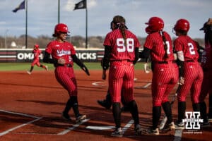Nebraska Cornhusker Hannah Camenzind (9) by in by Olivia DiNardo in the first against the Omaha Mavericks during a college softball game on Wednesday, March 26, 2025, in Omaha, Nebraska. Photo by John S. Peterson.