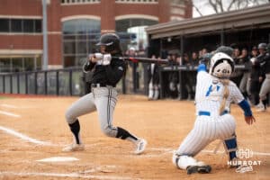 Omaha Mavericks Ava Rongisch dodges the wild pitch during a college softball game against Creighton on April 1st, 2025 in Omaha, Nebraska. Photo by Brandon Tiedemann.