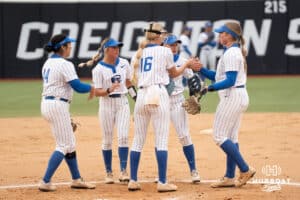 Creighton Bluejays meet at the mound during a softball game against Omaha on April 1st, 2025 in Omaha Nebraska. Photo by Brandon Tiedemann.