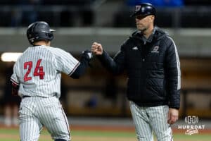 Omaha Maverick infielder Drew Borner (24) gets a fist bump from head coach Evan Porter run to home after hitting a home run against the Nebraska Cornhuskers during a college baseball game Wednesday, April 2, 2025 in Omaha, Nebraska. Photo by John S. Peterson.