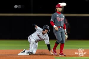 Omaha Maverick outfielder Eli Hoerner (10) steals second base against Nebraska Cornhusker utility Cayden Brumbaugh (0) in the seventh inning during a college baseball game Wednesday, April 2, 2025 in Omaha, Nebraska. Photo by John S. Peterson.