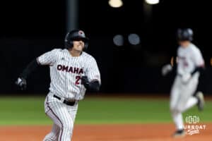 Omaha Maverick utility Sam Beck (21) advances to third base when Trout doubled against the Nebraska Cornhuskers in the sixth inning during a college baseball game Wednesday, April 2, 2025 in Omaha, Nebraska. Photo by John S. Peterson.