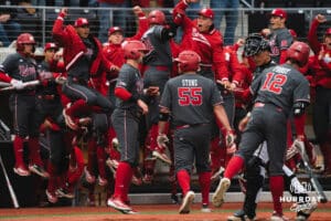 Nebraska Cornhuskers celebrate with jumps at the plate during a baseball game at Tal Anderson Field on April 2nd, 2025 in Omaha Nebraska. Photo by Collin Stilen.
