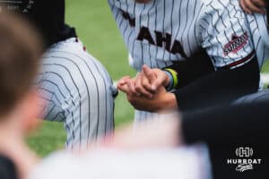 Omaha Mavericks holding hands while they pray during a baseball game at Tal Anderson Field on April 2nd, 2025 in Omaha Nebraska. Photo by Collin Stilen.