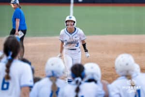 Creighton Bluejays Sydra Seville celebrates a grand slam during a college softball game against UConn Huskies on March 28th, 2025 in Omaha, Nebraska. Photo by Brandon Tiedemann.