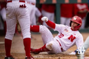 Nebraska Cornhusker catcher Hogan Helligso (10) slides into home to score a run against the Creighton Bluejays in the second inning during a college baseball game Tuesday, April 1, 2025 in Lincoln, Nebraska. Photo by John S. Peterson.