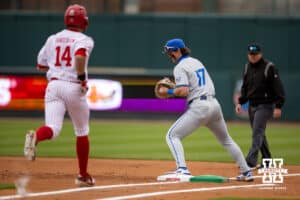 Nebraska Cornhusker utility Case Sanderson (14) grounds out Creighton Bluejay first baseman Will MacLean (17) makes the catch at first during a college baseball game Tuesday, April 1, 2025 in Lincoln, Nebraska. Photo by John S. Peterson.