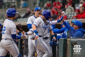 Creighton Bluejay outfielder Tate Gillen (20) gets a high five after scoring in the first inning against the Nebraska Cornhuskers during a college baseball game Tuesday, April 1, 2025 in Lincoln, Nebraska. Photo by John S. Peterson.