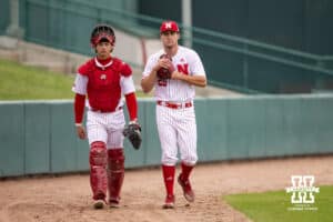 Nebraska Cornhusker pitcher TJ Coats (26) and catcher Hogan Helligso walk to the dugout to take on the Creighton Bluejays during a college baseball game Tuesday, April 1, 2025 in Lincoln, Nebraska. Photo by John S. Peterson.